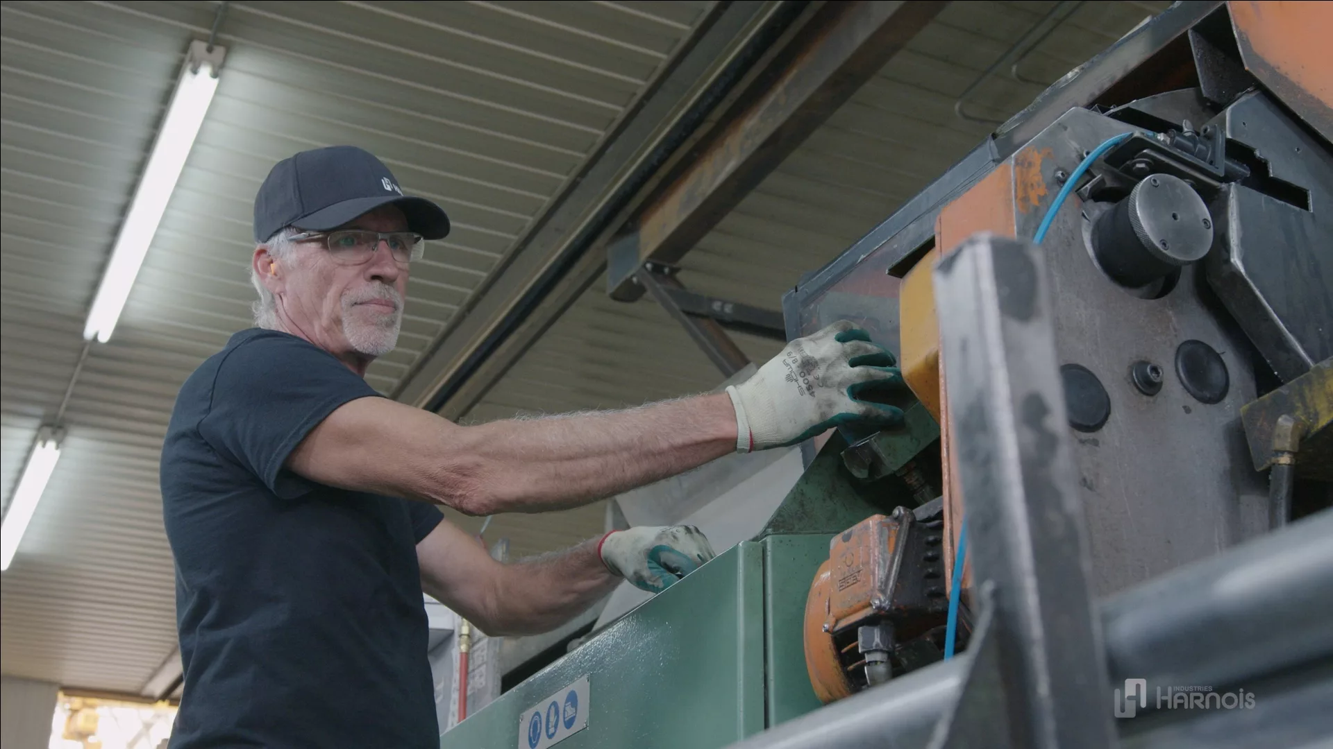 About Megadome Fabric Building: a worker on a machine