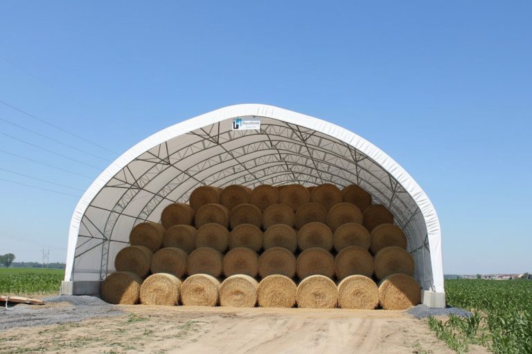 Round hay bales in a double pipe hoop barn